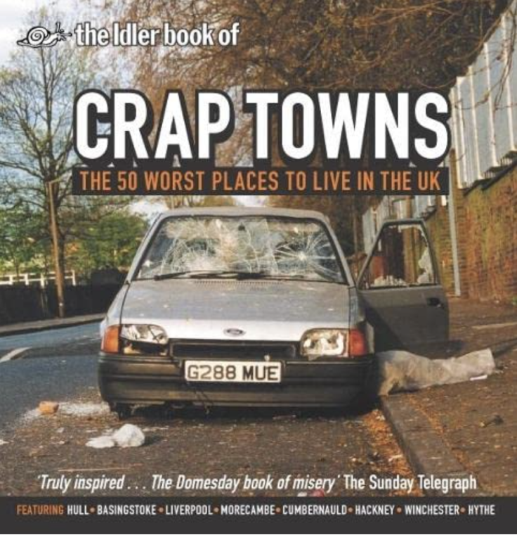 The Idler Book of Crap Towns: The 50 Worst Places to Live in the UK — book cover featuring a photograph of a vandalised car with smashed windscreen on a grey urban street