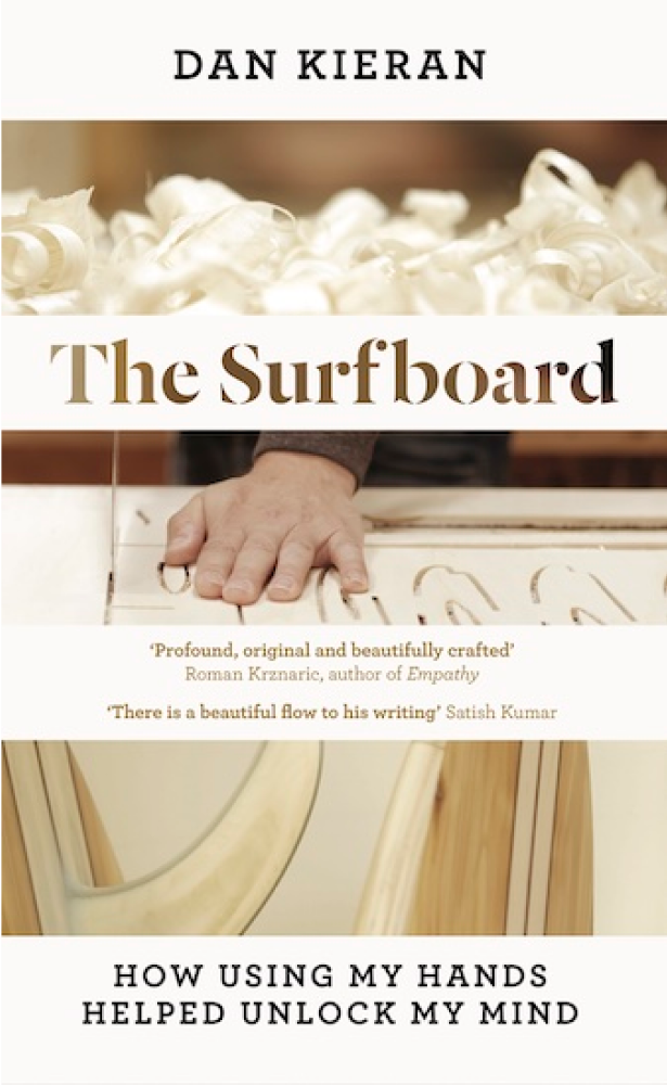 The Surfboard: How Using My Hands Helped Unlock My Mind by Dan Kieran — book cover featuring three photographic strips showing wood shavings, a hand smoothing a surfboard, and a shaped board hull